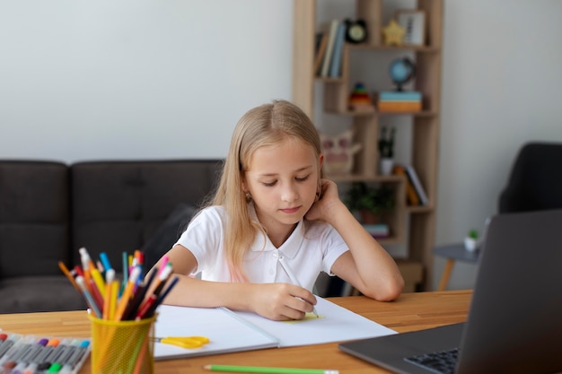 Photo little girl doing online classes