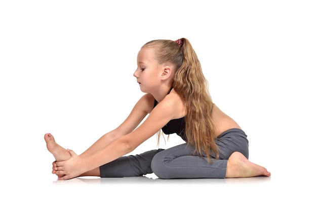 Little girl doing yoga exercise