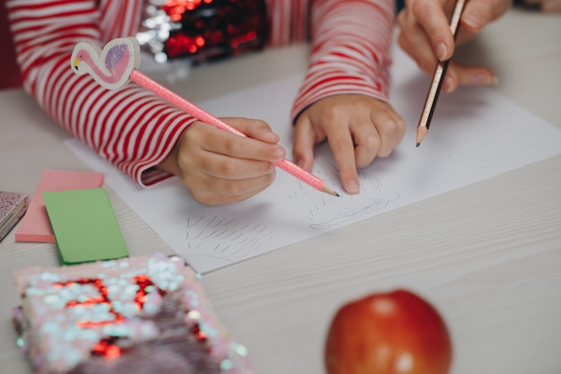 Little girl drawing on a paper