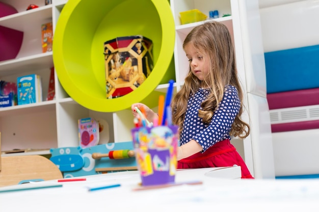 Little girl drawing at playroom