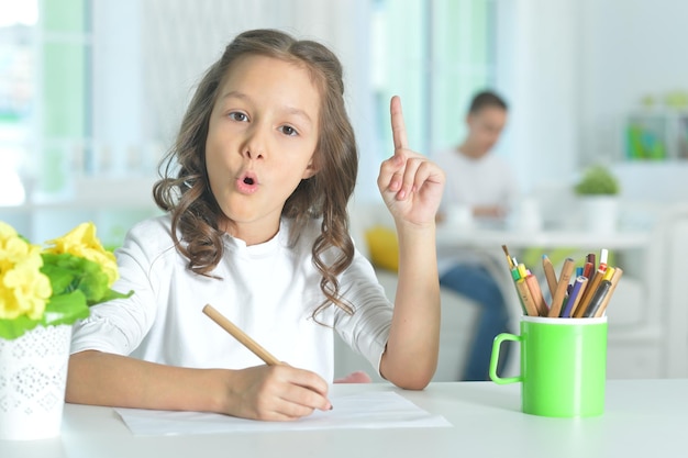 Little girl drawing with pencil