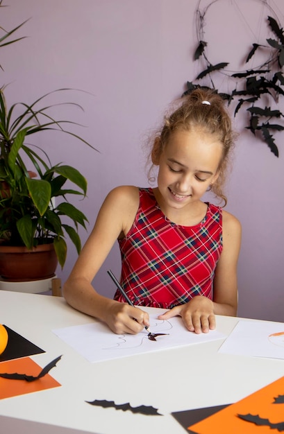 little girl draws on halloween