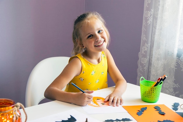 little girl draws on halloween