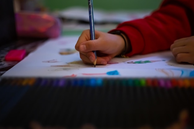 little girl draws at home creativity development pov child painting a picture with school supplies