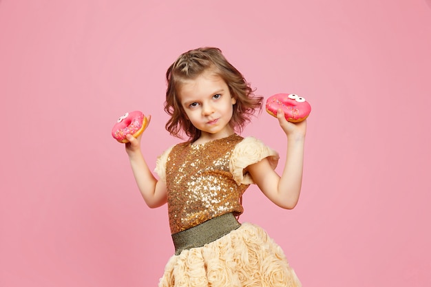 Little girl in dress with donuts