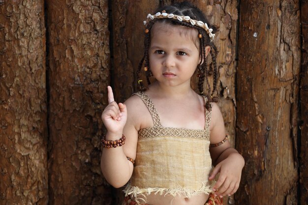 Little girl dressed as a native outdoors in summer High quality photo