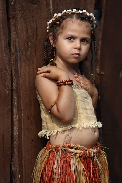 Little girl dressed as a native outdoors in summer. High quality photo