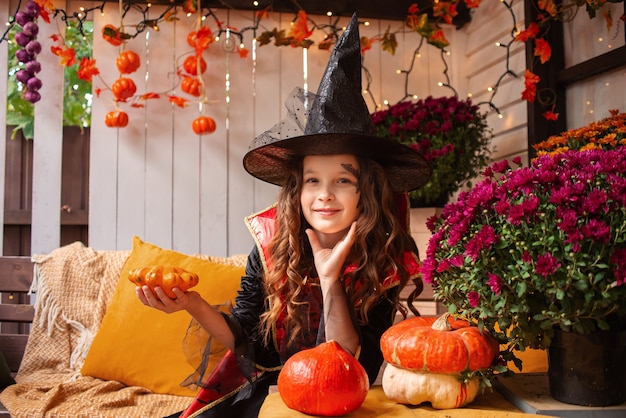 little girl dressed as a witch is having fun with halloween