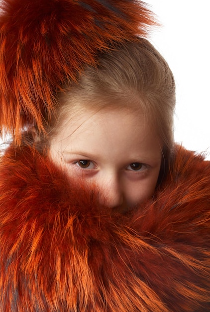 Little girl dressed with red fur-lined clothes