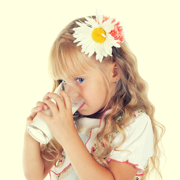 Little girl drinking milk from glass