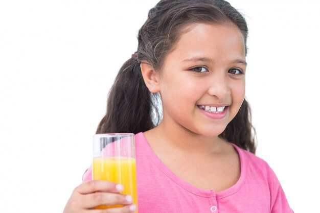 Little girl drinking orange juice