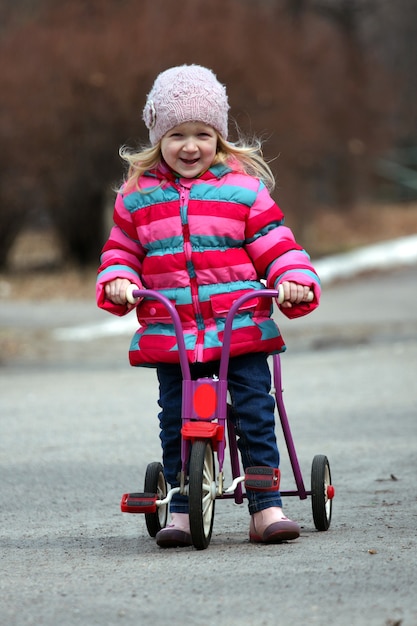 Little girl drive on a bike at the outdoors