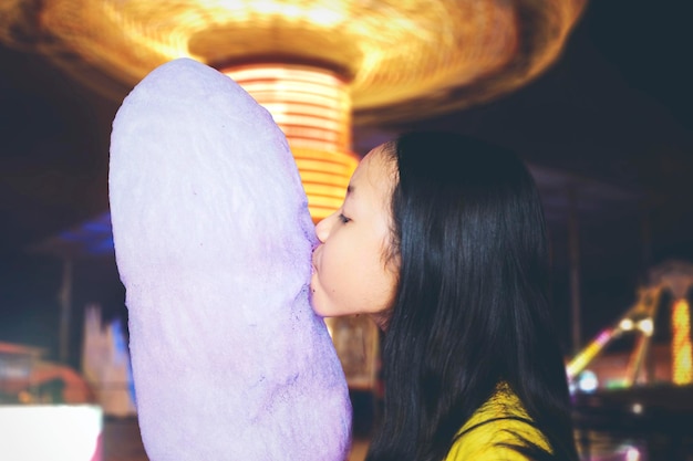 Little girl eating a big cotton candy