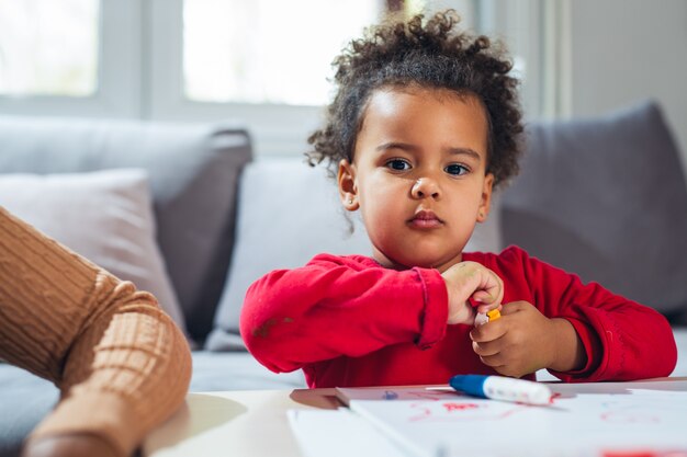 Little girl eating candies at home 