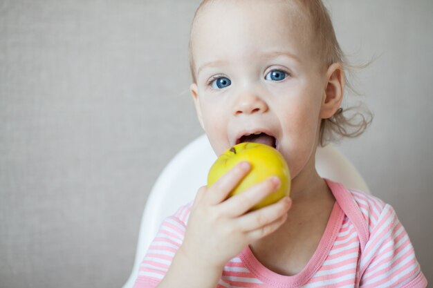 A little girl eating fresh apples