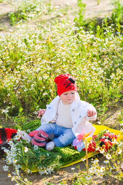 A little girl in embroidery stands in the field