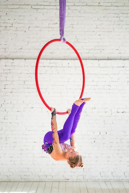 A little girl engaged in aerial gymnastics