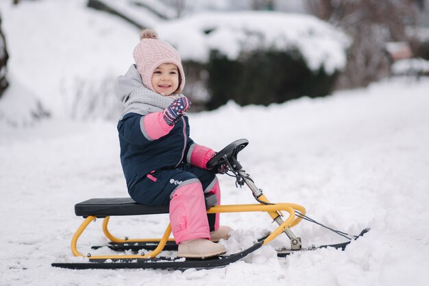 Little girl enjoy a sleigh ride