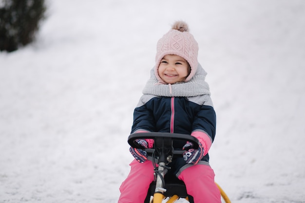 Little girl enjoy a sleigh ride