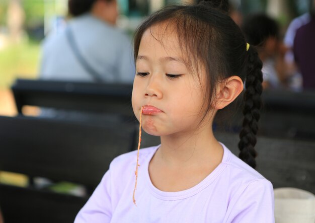 little girl enjoys eating pizza.