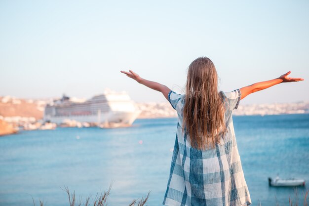 Little girl in european town outdoors on Mykonos island