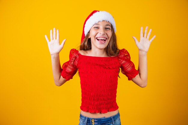 Little girl excited for expressive christmas on yellow background