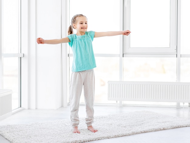 Little girl exercising in gym