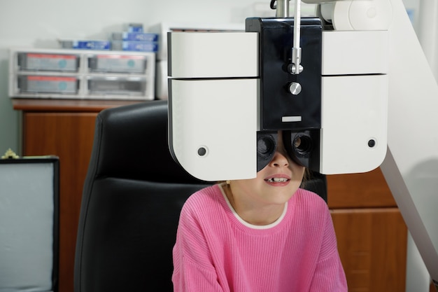 小さな女の子がクリニックで目のテストをします。