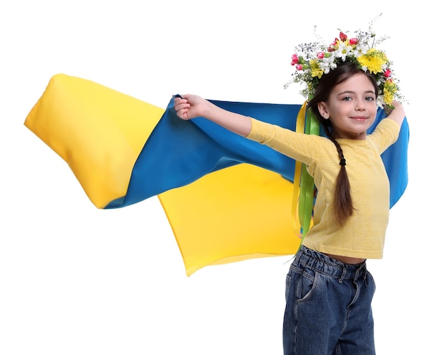 Photo little girl in flower wreath with flag of ukraine on white background