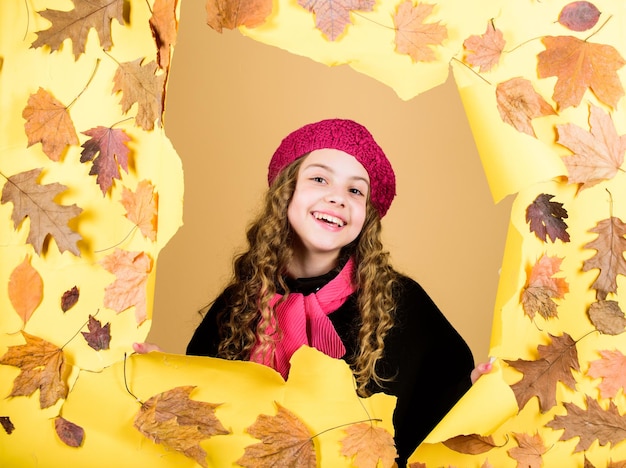 Little girl in french beret Fall fashion little girl in trendy coat and red scarf parisian kid in autumn leaves autumn beauty Happy childhood child has positive mood In love with nature