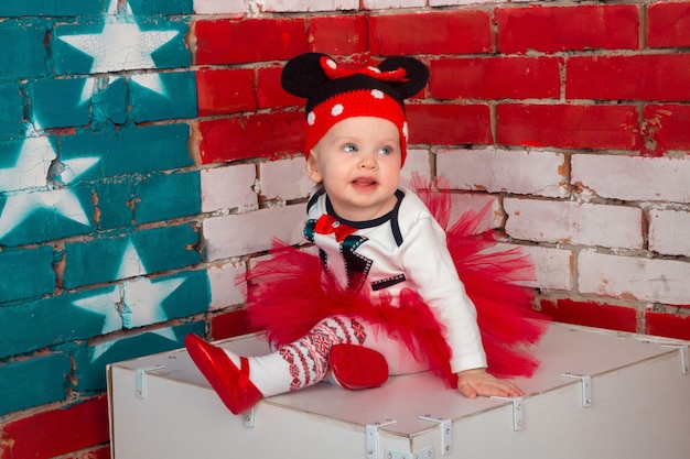 Little girl in a funny hat and red skirt