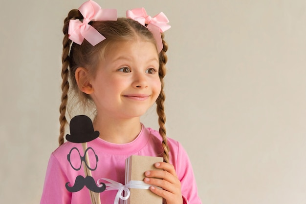 A little girl gives a gift for Father's Day.