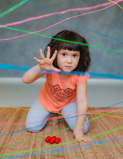 Little girl going through a rope web