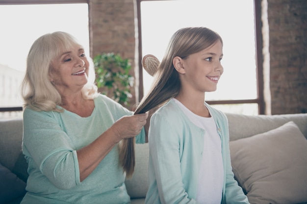 Little girl and grandmother sitting on the couch