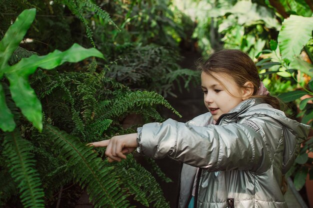 Little girl in a greenhouse or conservatory