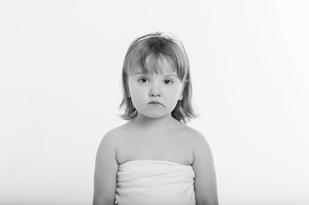 Photo a little girl grimaces against a white background.