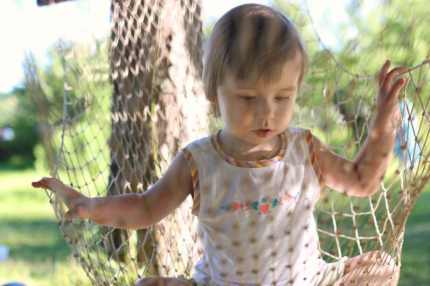 Little girl in hammock nature summer