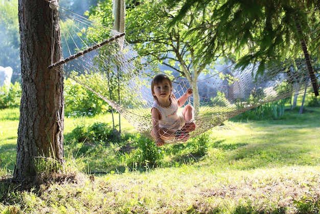 Little girl in hammock nature summer