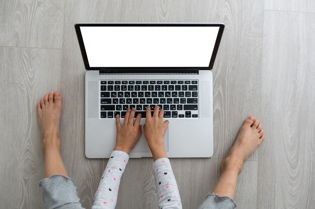 Little girl Hands using laptop. Online shopping in childhood.