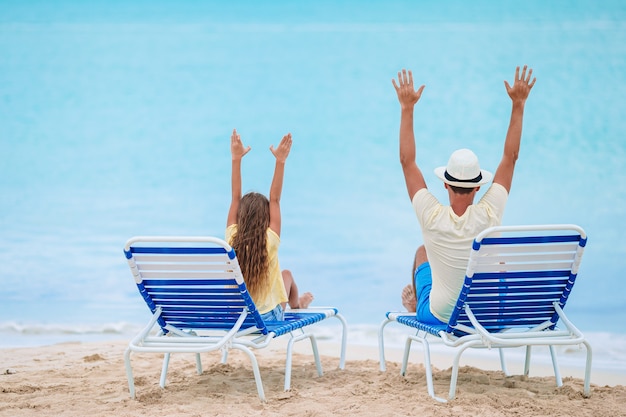 Little girl and happy dad having fun during beach vacation