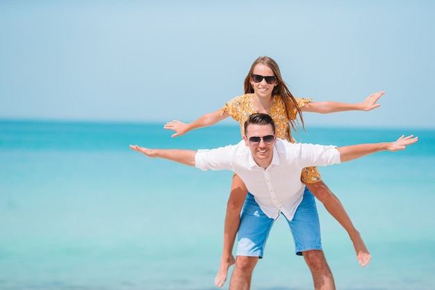 Little girl and happy dad having fun during beach vacation