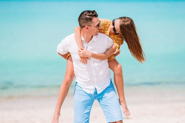 Little girl and happy dad having fun during beach vacation