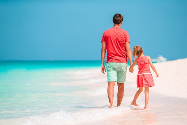 Bambina e papà felice divertendosi durante la vacanza della spiaggia