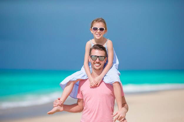 Bambina e papà felice divertendosi durante la vacanza della spiaggia