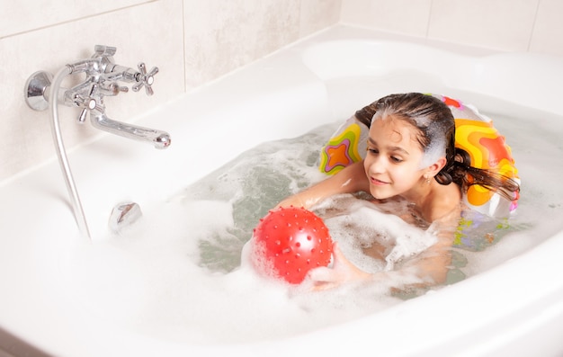 Little girl have fun in the bathtub