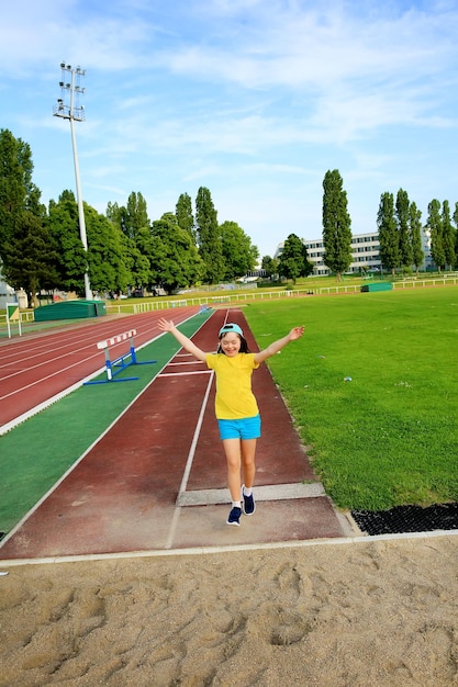 Little girl have fun on the stadium