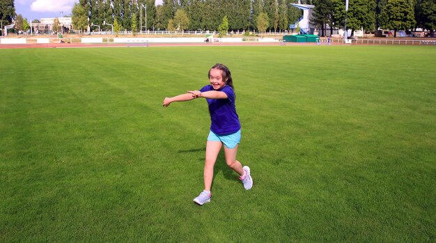 Little girl have fun on the stadium