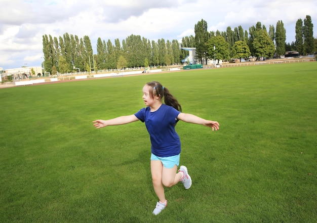 Little girl have fun on the stadium