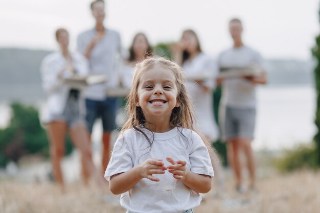 Little girl having fun at picnic, pizza, drinks, summer and lawn