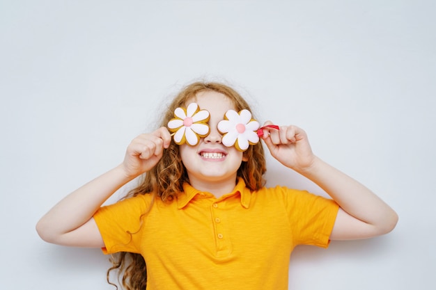 Little girl having fun with daisy eyes. 